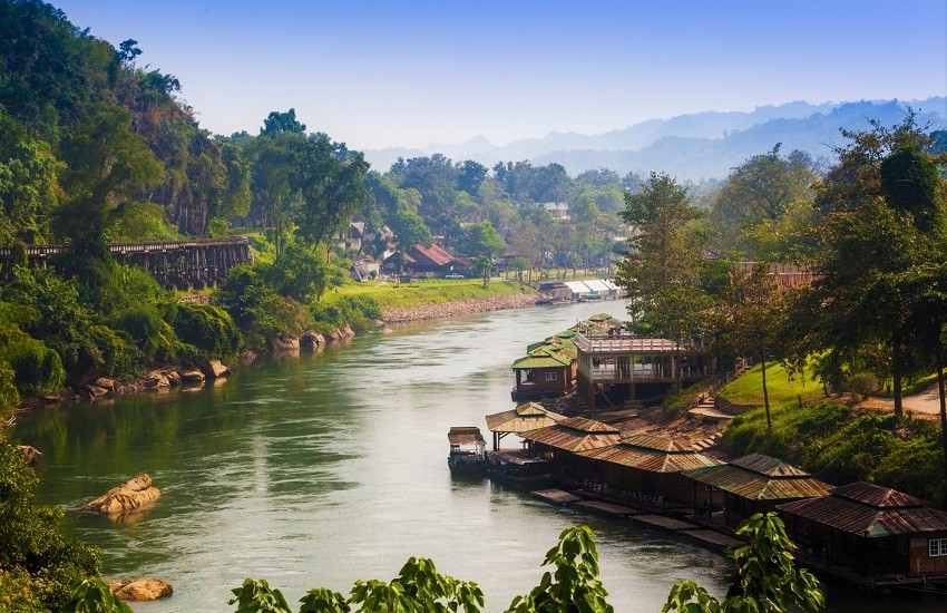 Death Railway along River Kwai with village and misty mountains