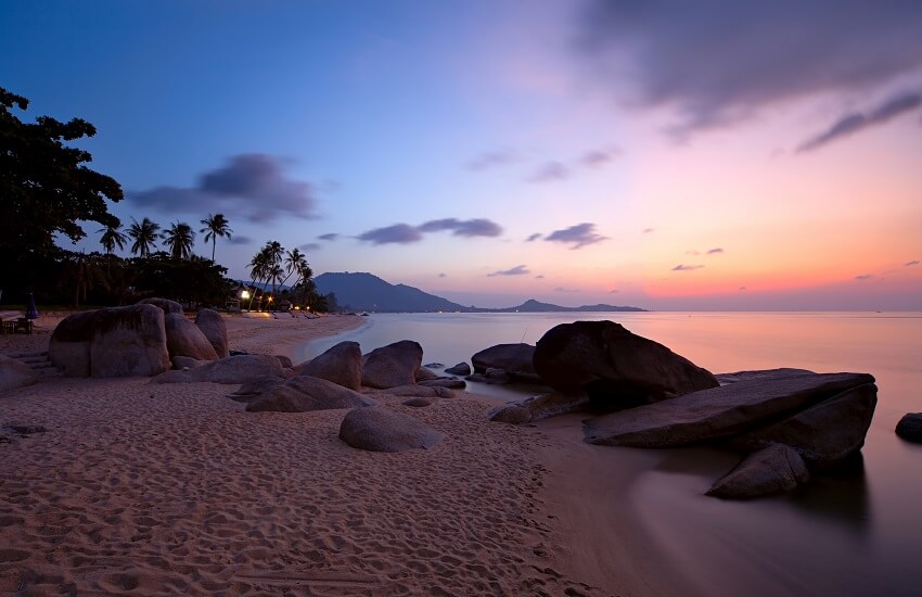 Rocks at Lamai Beach Koh Samui with sea and glowing sunset light