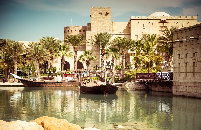Fort Island at Madinat Jumeirah, with calm canals and traditional wooden boats resting on the water.