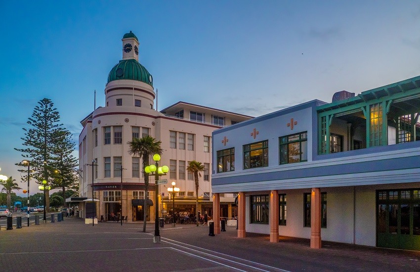 Art Deco town of Napier in New Zealand as a summer evening approaches, under a blue sky with a soft reddish glow