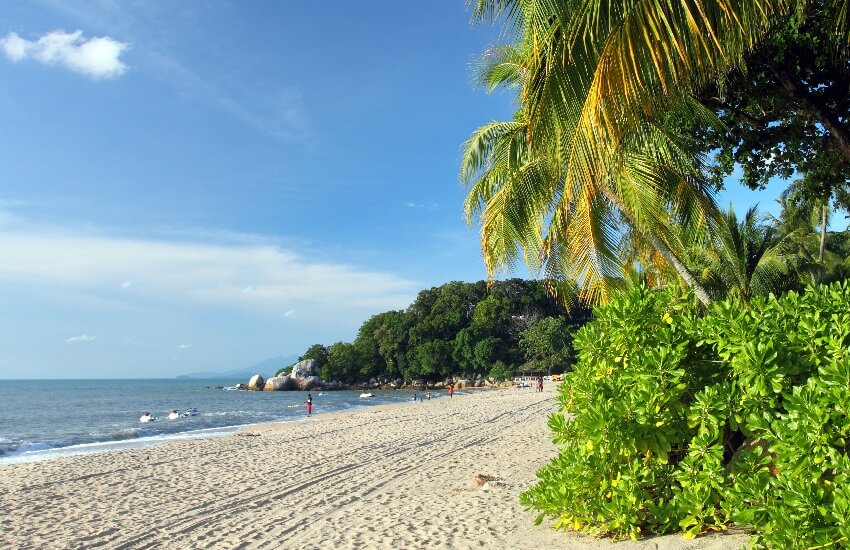 Sandy beach in Batu Ferringhi, stretching along the coastline of Penang Island.