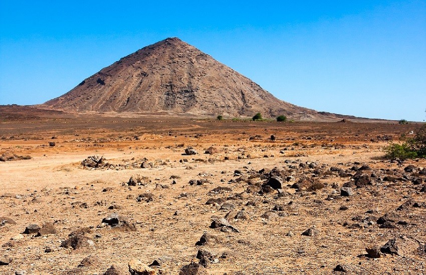 Volcanic crater and rugged rocks near Buracona Bay on Sal Island, with a Martian-like landscape.