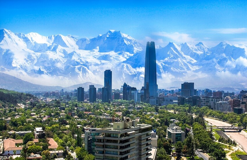 Santiago city skyline with snow-covered Andes mountains rising behind the city