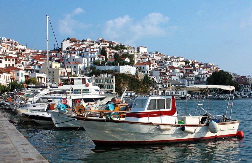 Boats in the port of Skopelos a Greek island and houses, in Sporades. Landscape