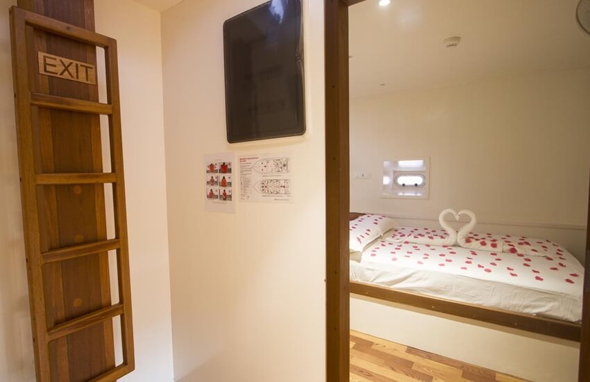 Cabins aboard a traditional Maldivian dhoni cruise boat, showing simple, comfortable accommodation on the water