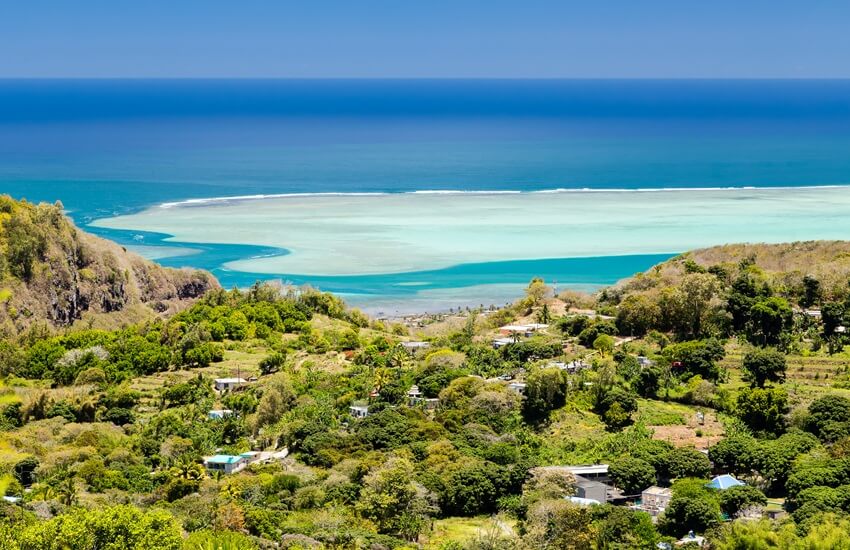 Lush green landscape of Rodrigues overlooking a turquoise lagoon stretching out to sea